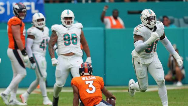 Miami Dolphins defensive end Emmanuel Ogbah (91) celebrates a sack Denver Broncos quarterback Russell Wilson (3) during the fourth quarter of an NFL game at Hard Rock Stadium in Miami Gardens, Sept. 24, 2023.